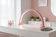 Pink arch-shaped lamp on a white background