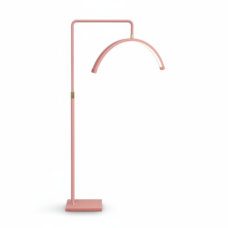 Pink floor lamp with curved arm on a white background