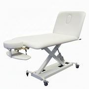 White hydraulic massage table on a white background