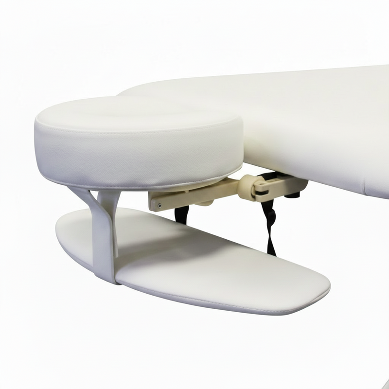 White massage table with adjustable headrest on a white background adjustable face cradle with arm rest for massage couch