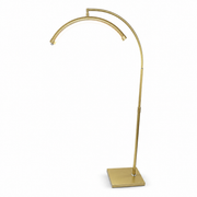 Gold arch-shaped floor lamp on a white background
