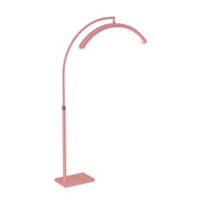 Pink floor lamp with curved design on a white background