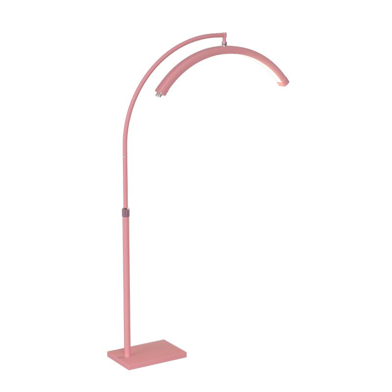 Pink floor lamp with curved design on a white background