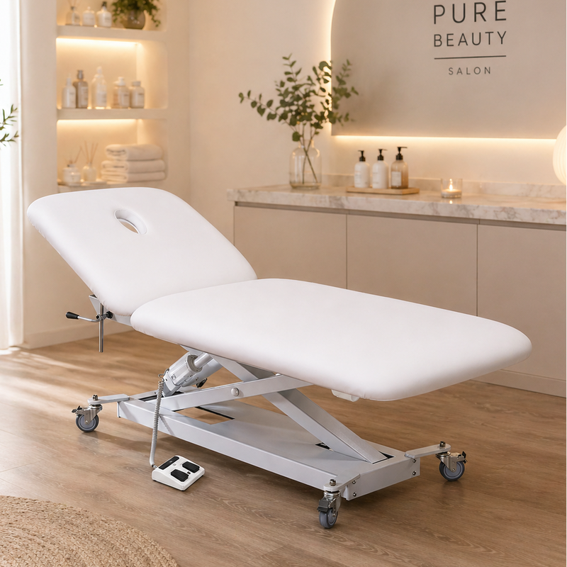White massage table in a spa setting with 'PURE BEAUTY SALON' branding.