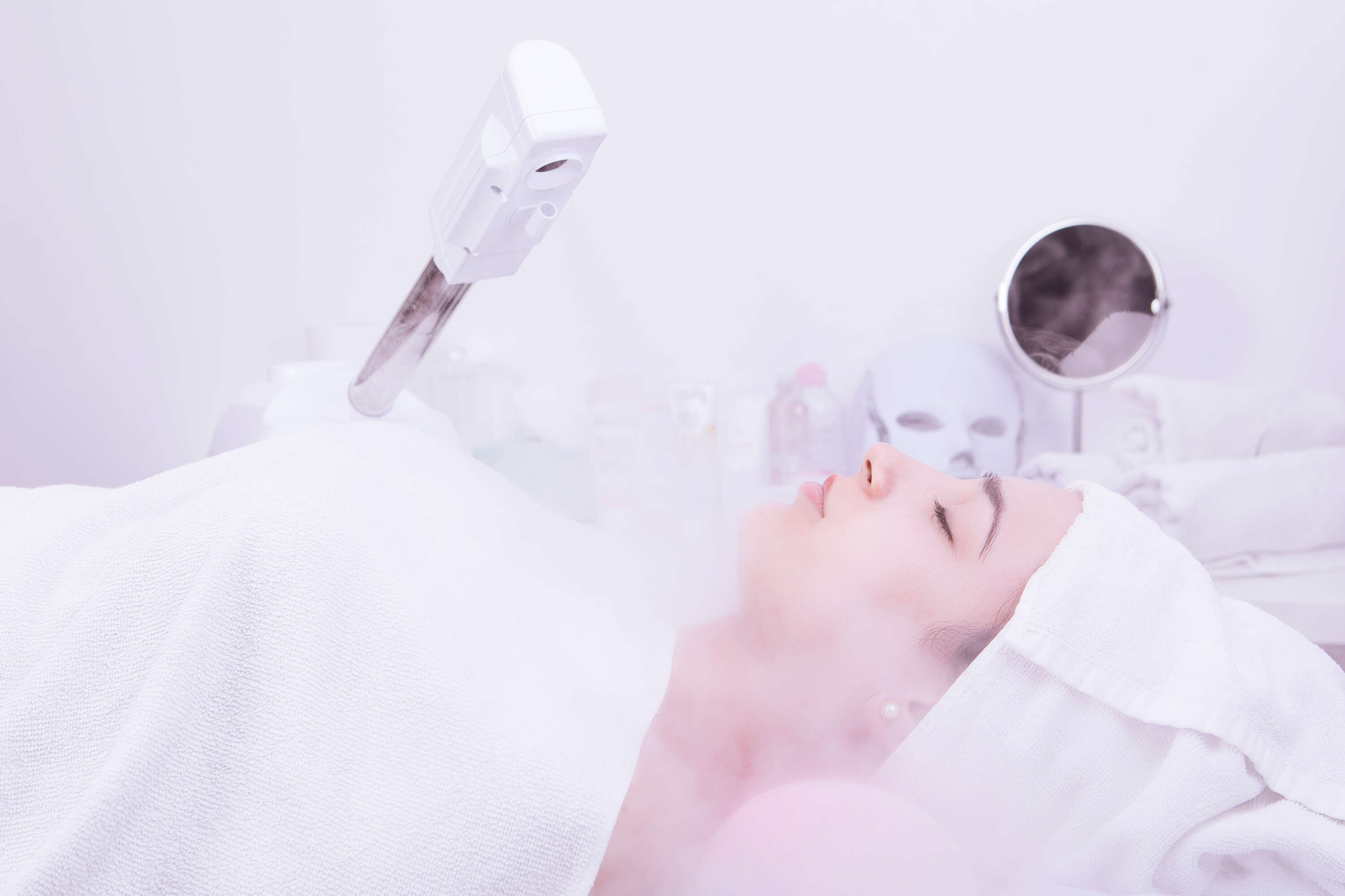 Beauty treatment of face with ozone facial steamer in beauty center. .